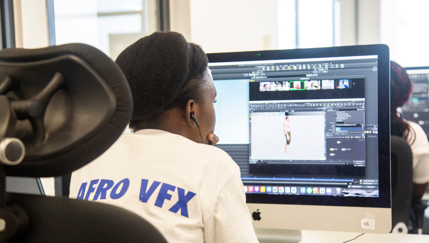 We look over the shoulder of a woman edits an animated movie on a computer
