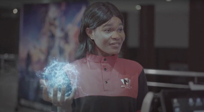 a woman in a black and red suit holds a blue orb, created with VFX